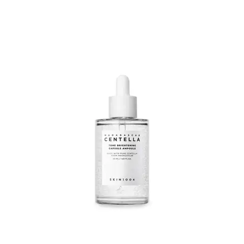 Skin1004 Madagascar Centella Tone Brightening Ampoule 50ml glass bottle with dropper, showing suspended white capsules.