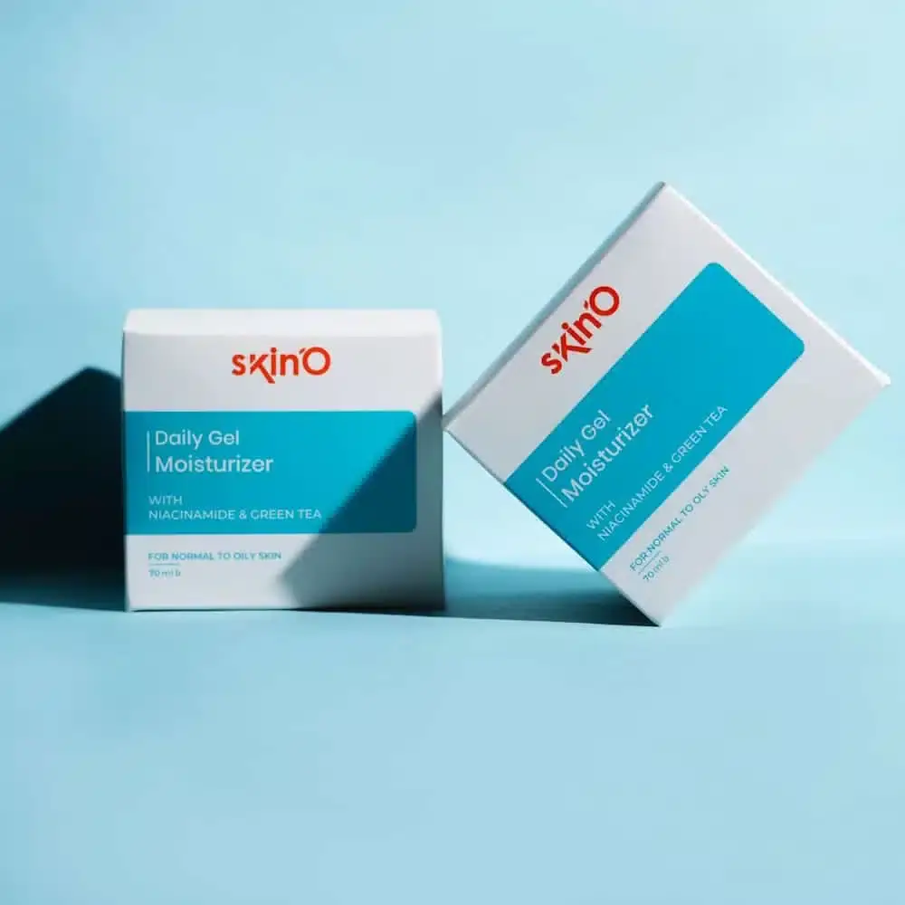 Angled view of Skino Daily Gel Moisturizer tube, revealing clear niacinamide and green tea gel inside. - thumbnail