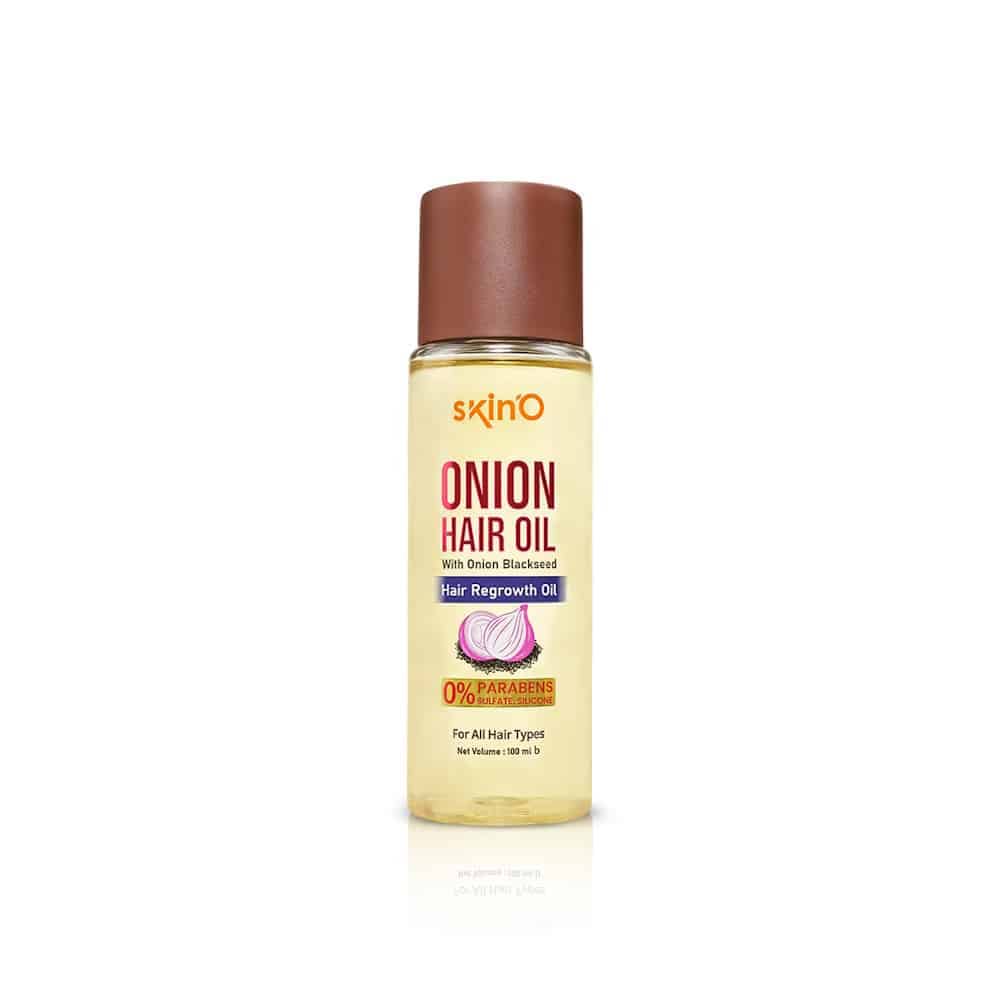 SkinO Onion Hair Regrowth Oil 100ml amber bottle standing upright, with natural green leaves. - thumbnail