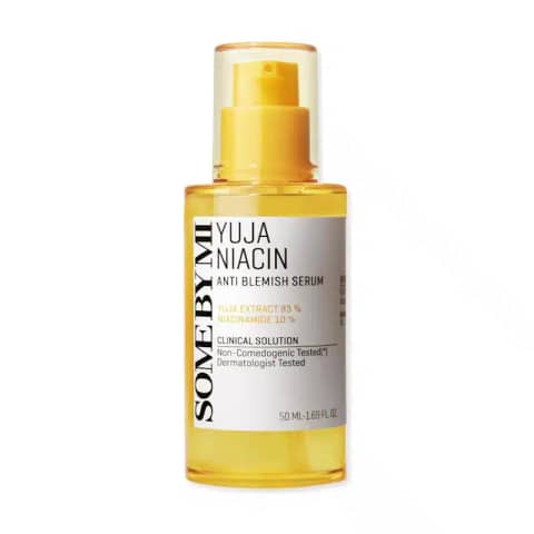 Clear SOME BY MI Yuja Niacin Anti-Blemish Serum 50ml bottle showing its luminous yellow liquid contents.