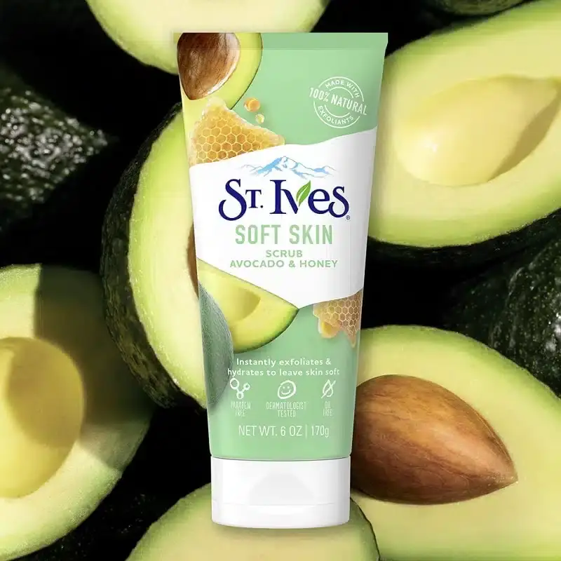 Close-up of St. Ives Soft Skin Avocado & Honey Scrub, showing light green creamy texture with exfoliating particles. - thumbnail