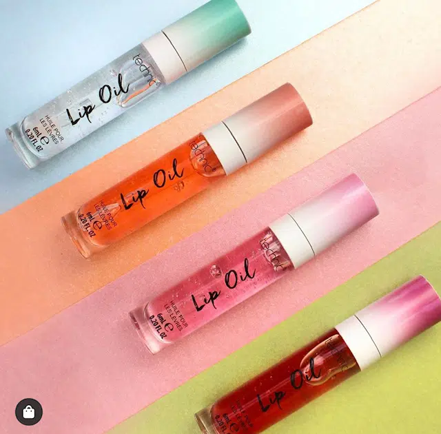 Three Technic Cherry Lip Oil tubes displayed, one open revealing its clear, soft applicator. - thumbnail