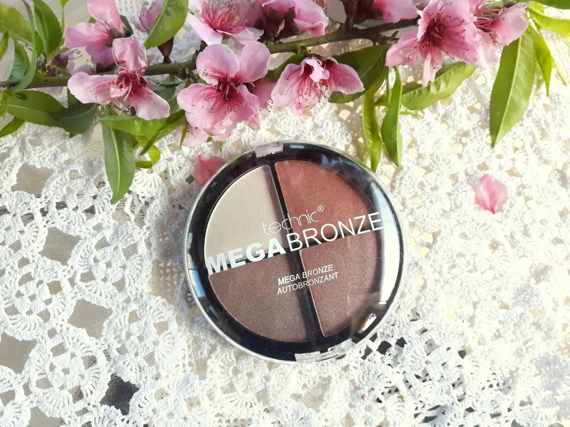 Open Technic Mega Bronze compact, revealing the rich bronze powder texture and inner mirror. - thumbnail