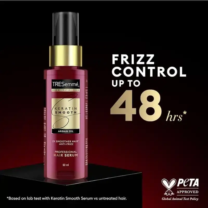 Tresemme Keratin Smooth hair serum dispensed onto fingertips, showing clear texture. - thumbnail