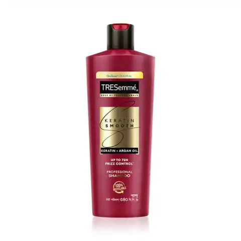 Full Tresemme Keratin Smooth Shampoo 340ml black bottle with elegant gold pump dispenser on white.