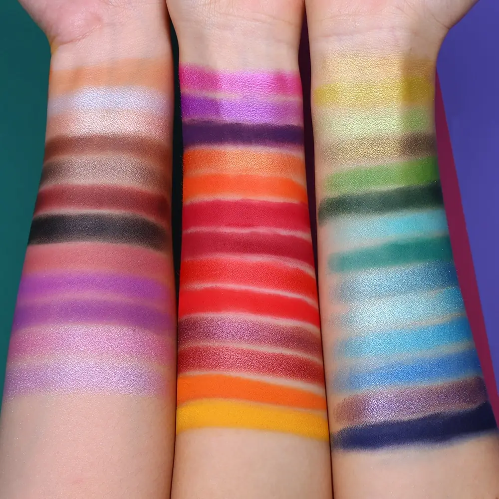 Close-up of UCANBE Spotlight Palette eyeshadow pans, highlighting shimmery, glitter, and matte textures. - thumbnail