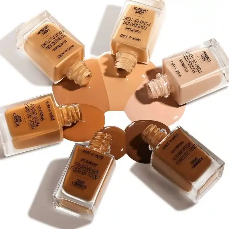 Wet N Wild Dewy Lumineux Foundation bottle tilted, revealing the black pump dispenser without the cap. - thumbnail