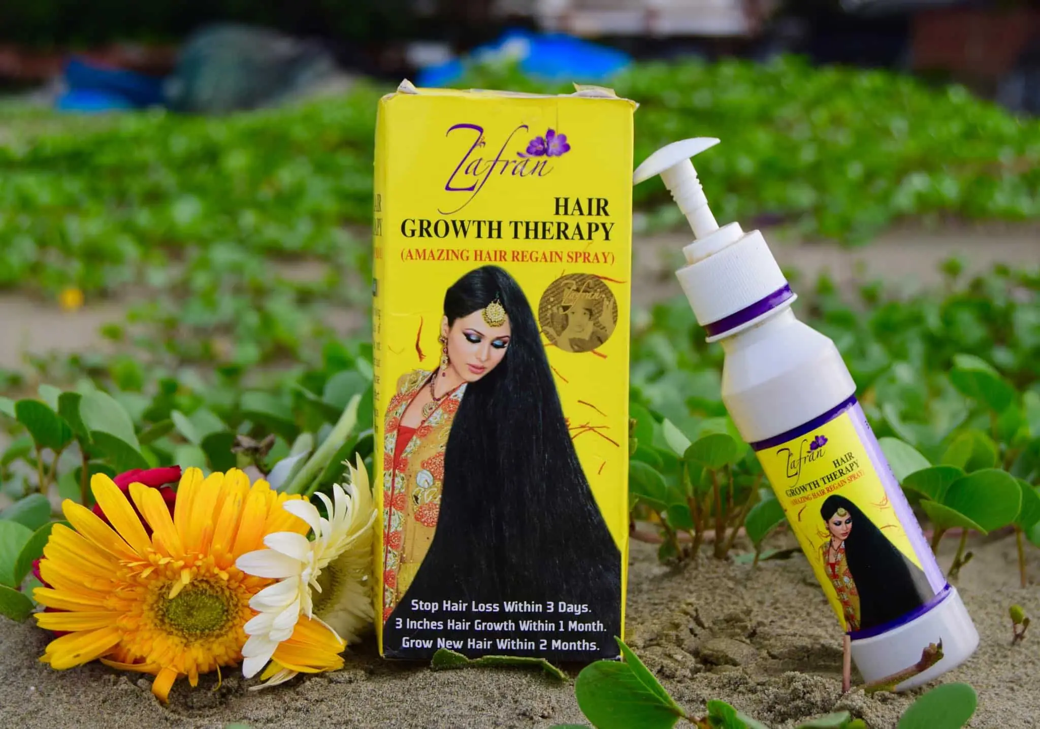 Zafran Hair Growth Therapy oil pouring from bottle onto a spoon, showing its rich golden color. - thumbnail